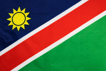 National flag of the state of Namibia close up. State background.