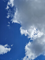 White cumulus clouds in the summer sky background