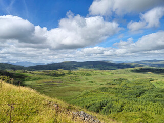Fototapeta premium Green hills under blue summer sky landscape in Ireland