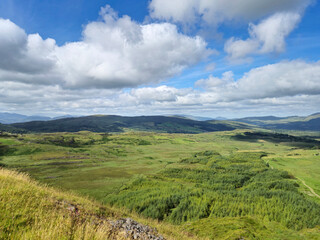 Green hills under blue summer sky landscape in Ireland