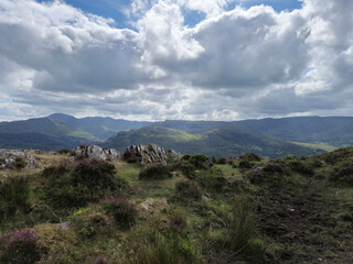 Green hills under blue summer sky landscape in Ireland
