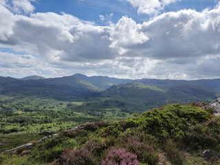 Green hills under blue summer sky landscape in Ireland