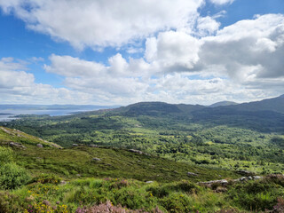 Green hills under blue summer sky landscape in Ireland
