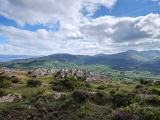 Green hills under blue summer sky landscape in Ireland