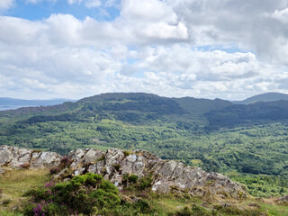Green hills under blue summer sky landscape in Ireland