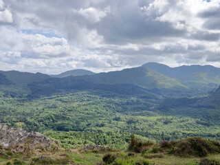 Green hills under blue summer sky landscape in Ireland