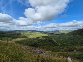 Green hills under blue summer sky landscape in Ireland