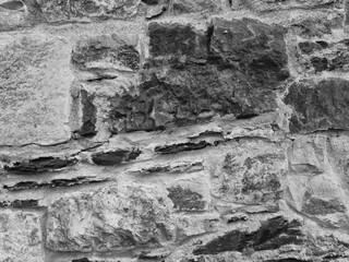 Stone wall patter close view background, natural stones black and white grayscale texture