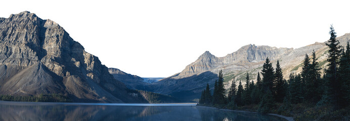 A large rocky mountain in the background with a glacier and a calm blue lake in the foreground. A treed shoreline fills the right side of the frame. The sky is transparent
