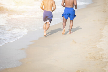 Two friends walking on the beach and footprints on the beach