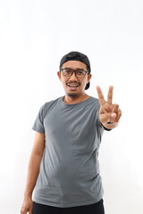 Fototapeta premium Asian man over isolated white background smiling looking to the camera showing fingers doing victory sign. Number two.