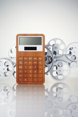 Calculator and gear wheel on a white background.
