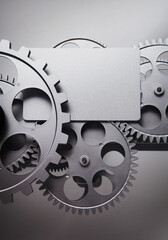 card and gear wheel on a gray background.
