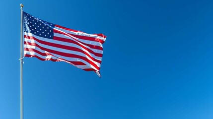 An American Flag Waves Against a Clear Blue Sky