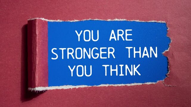 You are stronger than you think message writing on ripped red torn paper on blue background. Conceptual you are stronger than you think symbol.