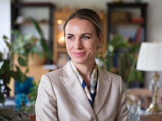 Woman in suit looking away. Confident woman in a cream blazer with a patterned scarf, looking away thoughtfully, suggesting contemplation or decision-making.