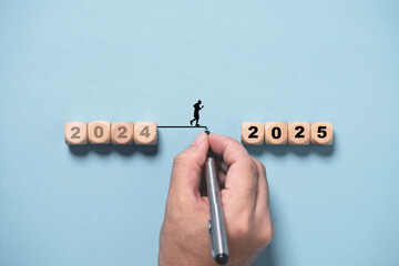 Hand writing line to connect between 2024 to 2025 for change and preparation merry Christmas and...