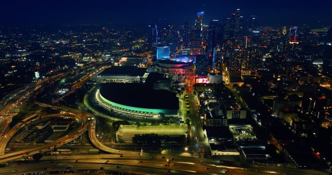 Stunning night view of modern Los Angeles, California, USA. Drone footage above the famous interchange near the downtown with mighty skyscrapers. Aerial view.