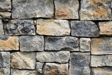 Obraz premium A Close-Up View of a Stone Wall Constructed with Varied and Irregularly Shaped Stones