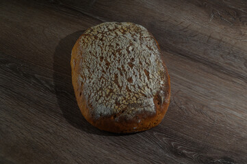 Sourdough bread loaf in bakery on wooden rustic table