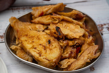 Seitan roast flavored with spices, glazed and served on metal plate board