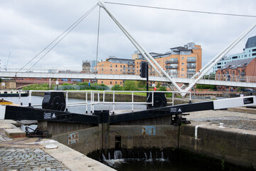 Obraz premium Leeds England: 3rd June 2024: Leeds Lock on the Aire and Calder Navigation with a historic control tower on Leeds Liverpool Canal