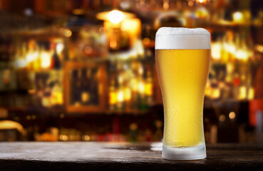 glass of beer in a bar on wooden counter