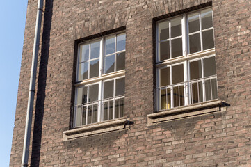 Fototapeta premium facade of an older brick building with windows