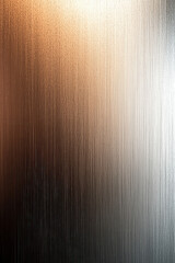 An abstract artwork featuring vertical blurred lines transitioning in gradient from warm orange to cool gray, creating a dynamic and contemporary visual appeal.