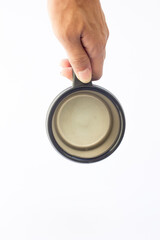 A black travel mug, held by a human hand, features a matte finish and an open hinged lid, revealing the drinking spout. Suitable for travel accessory or daily life themes.