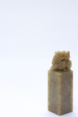 A polished jade stamp with a handle, used for imprinting wax seals on letters and envelopes. © daniel limantara