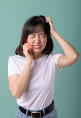 toothache jaw pain. asian young woman touching her mouth, expression, suffering from toothache,...