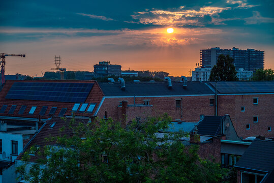 Roofs of brick buildings with beautiful sky during sunset