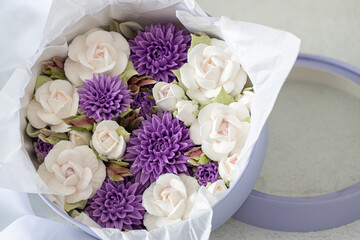 Zephyr bouquet of Flowers in a pink box on a light background, holiday concept.
