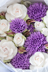 Zephyr bouquet of Flowers in a pink box on a light background, holiday concept.