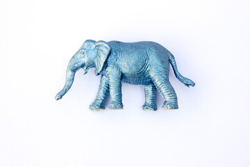 A miniature plastic elephant figurine, meticulously crafted in metallic blue. Its whimsical design captures the essence of this majestic animal, making it an ideal addition to toy collections, decorat