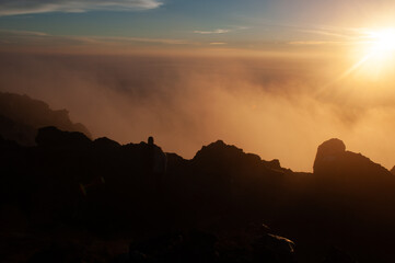 Volcanic rocks from the Merapi mountain in silhouette with the early morning sunrise light.