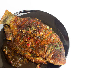 Fried Soy Sauce Gouramy Fish: A mouth-watering image of a crispy fried gouramy fish glazed with a savory soy sauce, perfect for editorial and commercial use in food and lifestyle publications.