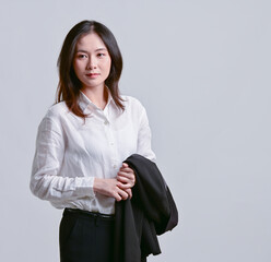 A beautiful Asian model in office clothes.