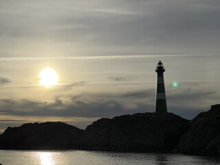 Lighthouse on the coast of Norway at sunset