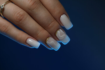 Beautiful nude manicure. Manicure with gel polish. Close-up of the hands of a young woman with a delicate nude 