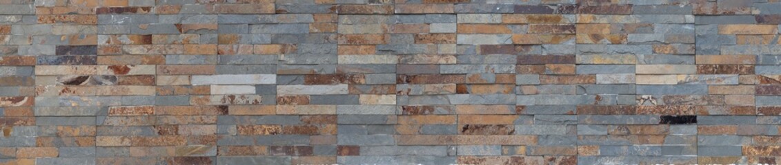 Panoramic texture of bronzed artisanal stone, with oxidized colors of gray, beige, and orange. vibrant surface