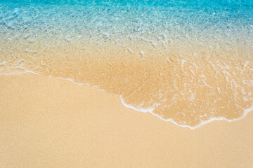 wave on sand beach top view.