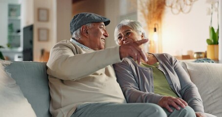 Old couple, laughing and watching tv together in home, support and touch for comfort in lounge. Elderly people, comedy film and funny humor in retirement, talking and bonding for love in marriage