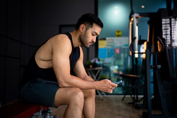 Fototapeta premium A strong Asian man is exercising to build muscle.