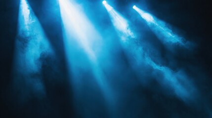 Fototapeta premium Bright blue spotlights shine through a smoky haze, creating a dramatic and atmospheric scene.