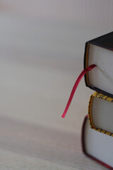 Close-up of three stacked books, showcasing their textured spines and edges. An ideal background...