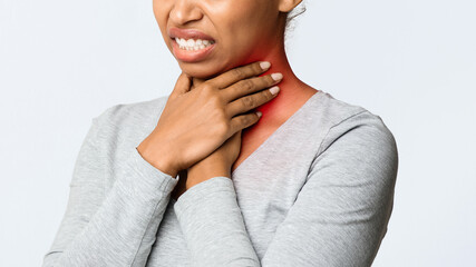 Angina, tonsillitis. Cropped of black woman holding her inflamed throat, panorama with free psace