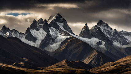 Majestic snow-capped mountain range under dramatic sky with striking contrast and peaks.