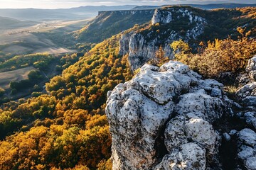 Obraz premium Autumn Landscape with Rocky Cliffs and Forest in the Valley